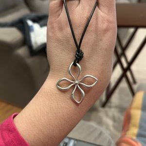 I’m selling a fossil necklace made with knotted leather and adjustable chain.